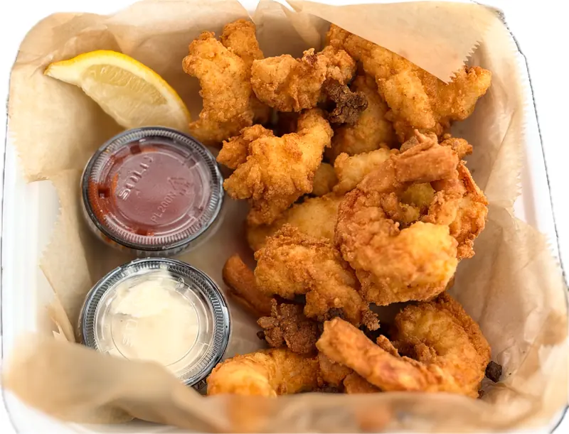 Fried shrimp basket with lemon, cocktail sauce and tartar sauce